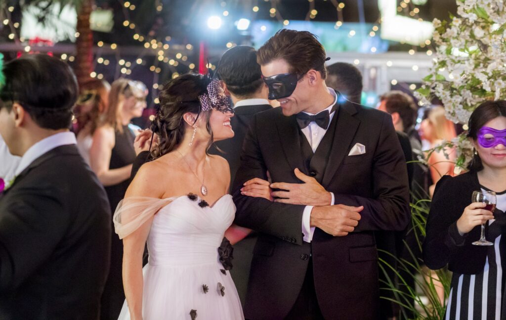 Helen works in a flower shop and her best friend Henry at the botanical gardens. At a masquerade gala, she thinks a masked man is Henry but hes actually off working. Enchanted by the dashing stranger, Helen is disappointed when he abruptly races off, dropping his rose boutonniere. Love-struck, she recognizes the rose, finds the buyer and they begin dating, until Helen finds out he has plans to turn the botanical gardens into condos. Meanwhile, Henry takes off, sure that Helen loves another man. Hes always wanted more than friendship, but when Helen finally admits she does too, Henry is already gone. Finding solace in her work, Helen is asked to deliver flowers to someone and is met with the most romantic surprise of her life.  Photo:  Credit: Copyright 2018 Crown Media United States LLC/Photographer: Shane Mahood